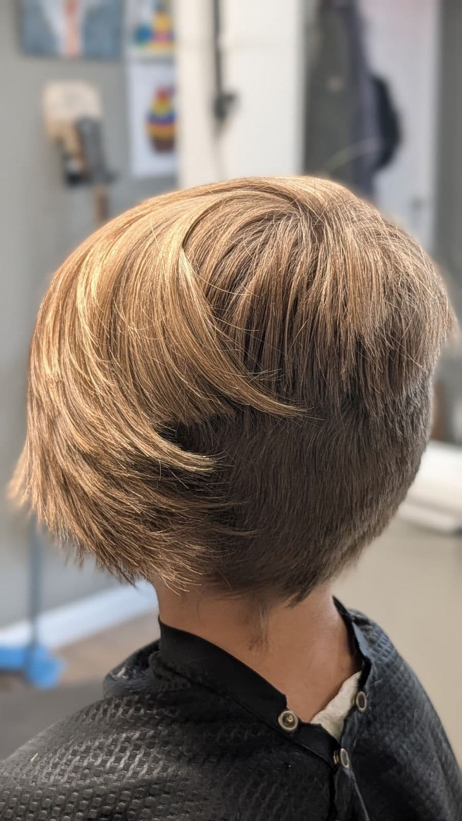Back view of a stacked bob haircut for a young client at Gary's Barber Shop