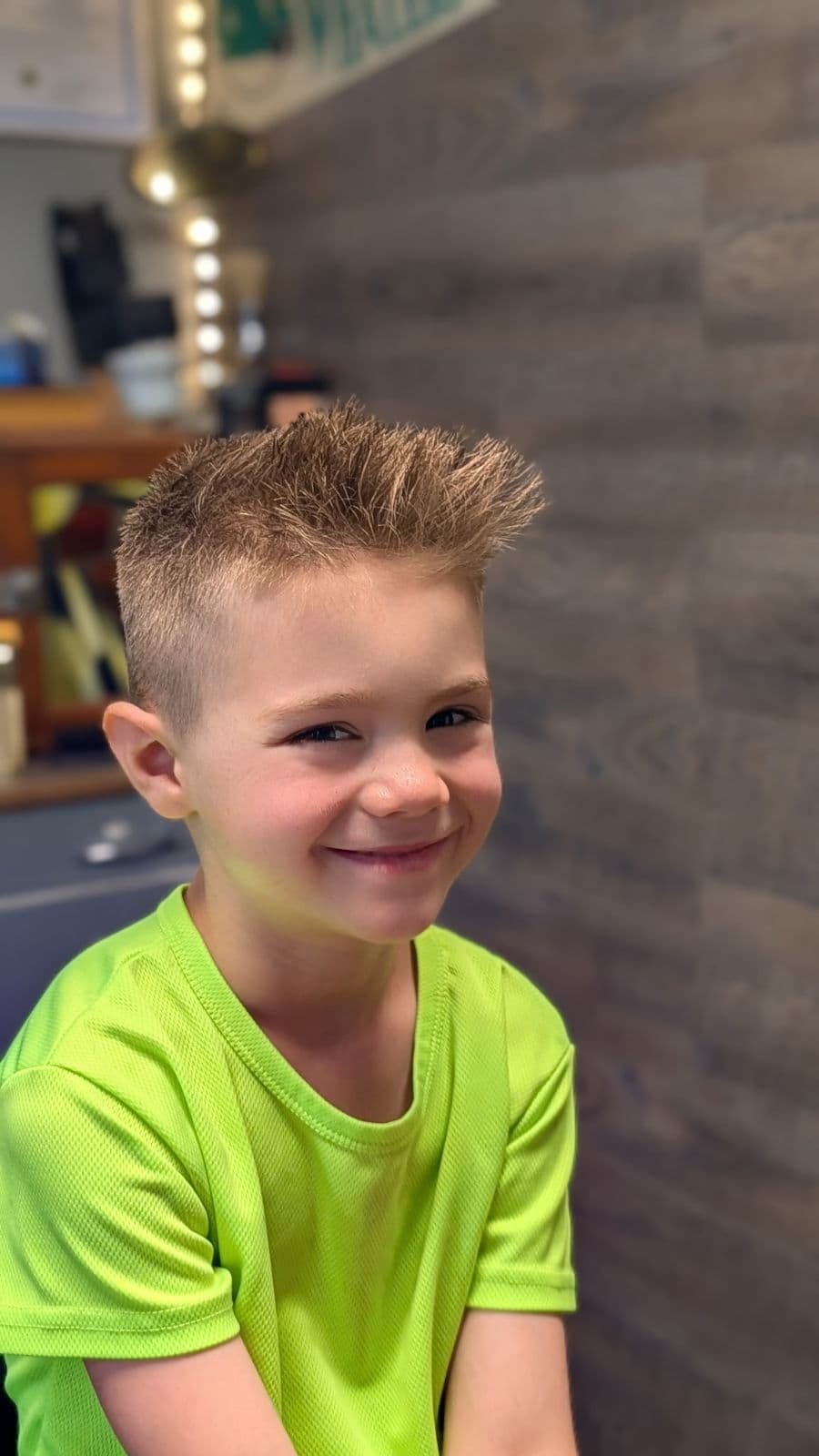 Young client with a textured spiky fade haircut at Gary's Barber Shop