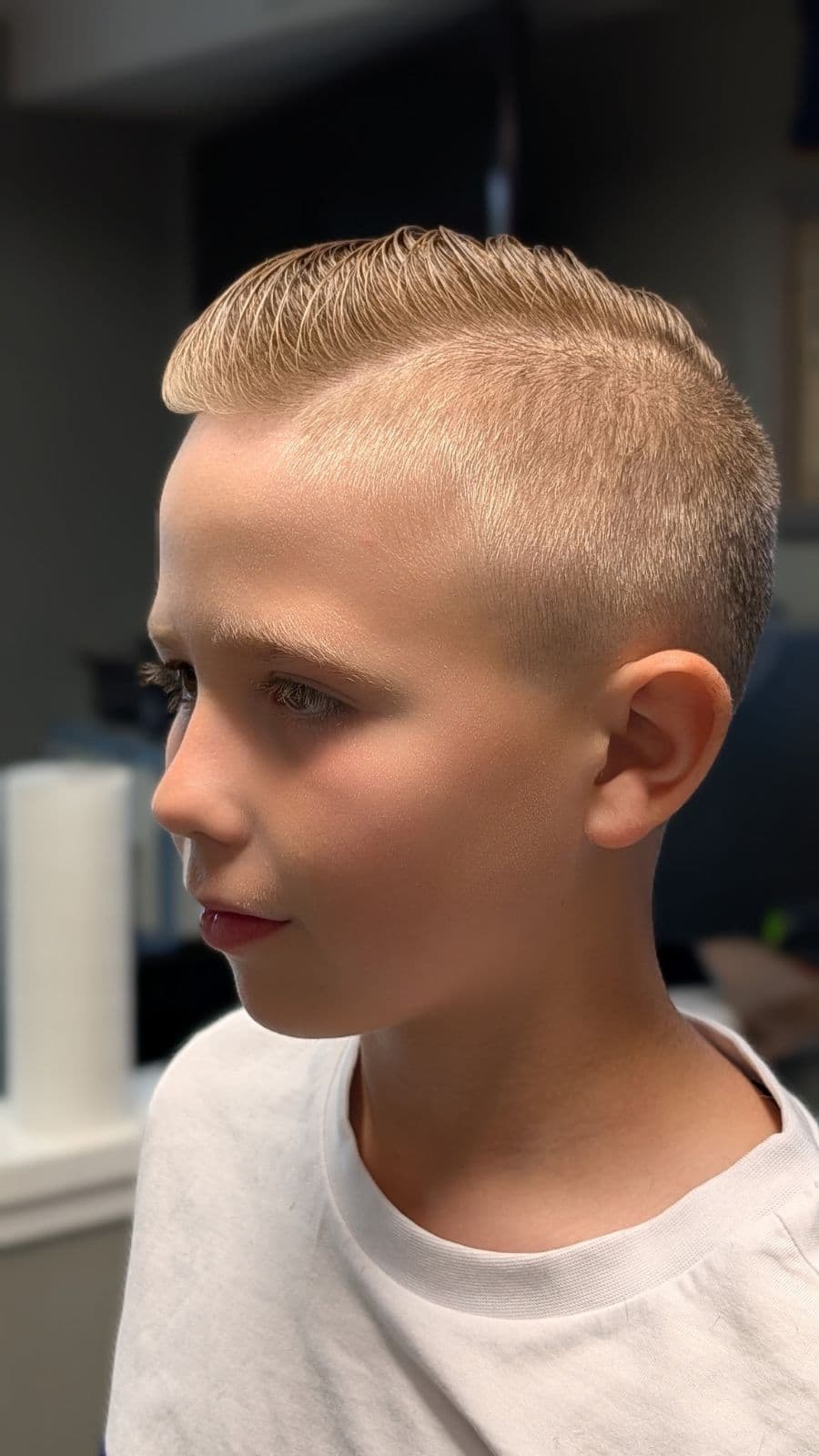 Young client with a blond side-part and high fade at Gary's Barber Shop