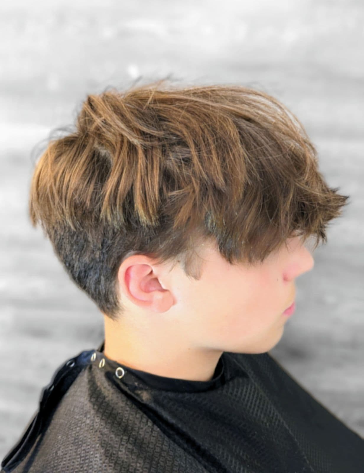 Textured crop with a tapered back on a teenage client at Gary's Barber Shop
