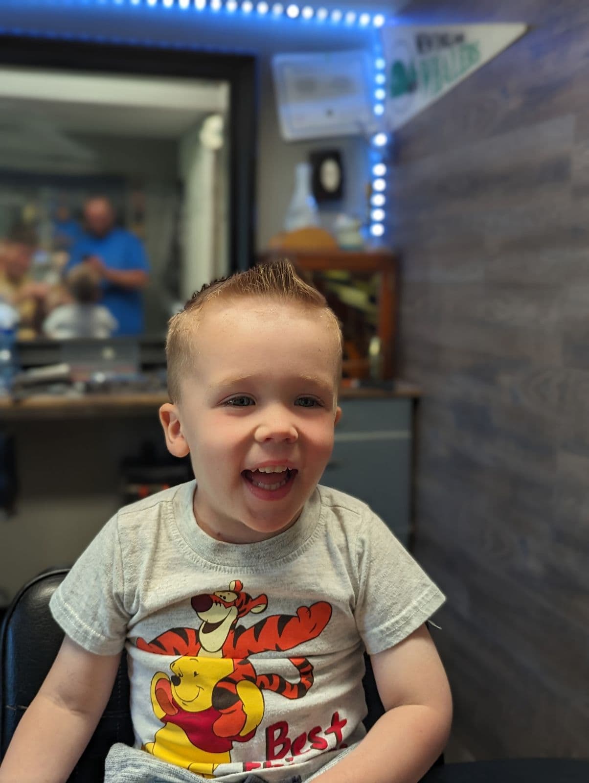 Toddler with a spiky cut in the barber chair at Gary's Barber Shop