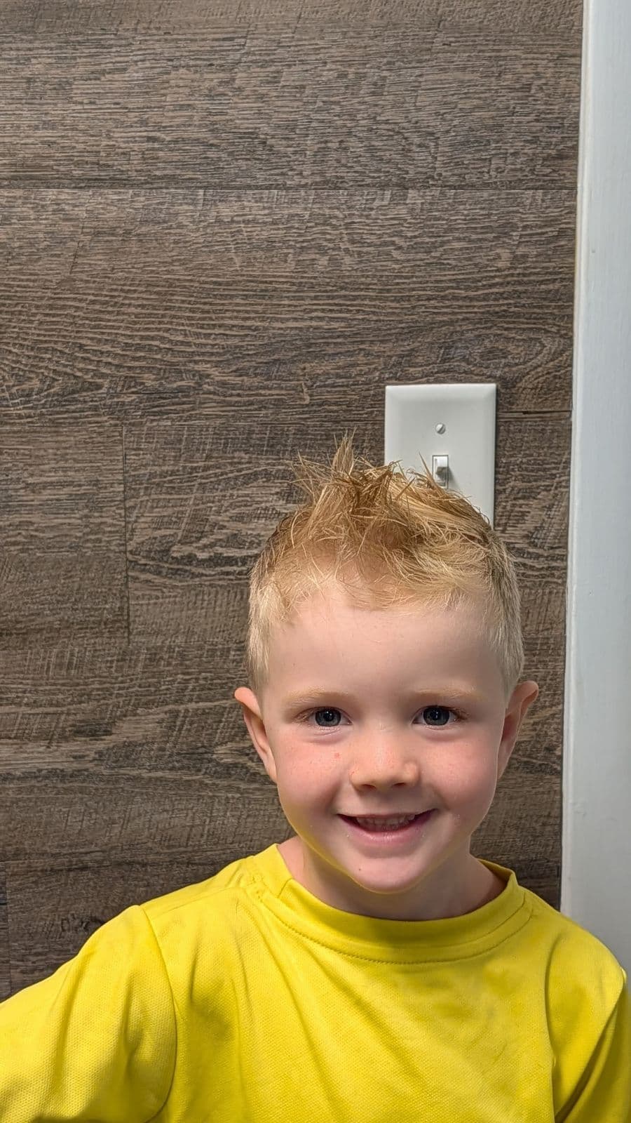 Young client showing off a spiky textured haircut from Gary's Barber Shop