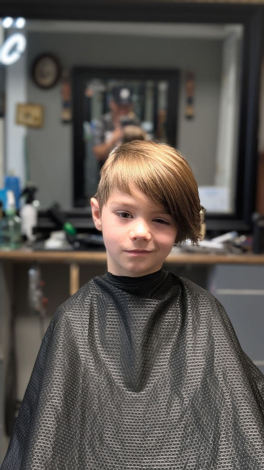 Young client with a side-swept fringe haircut at Gary's Barber Shop